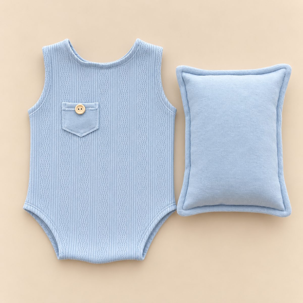 Pastel baby blue pointelle sleeveless newborn photography romper with pocket button and matching rectangular posing pillow