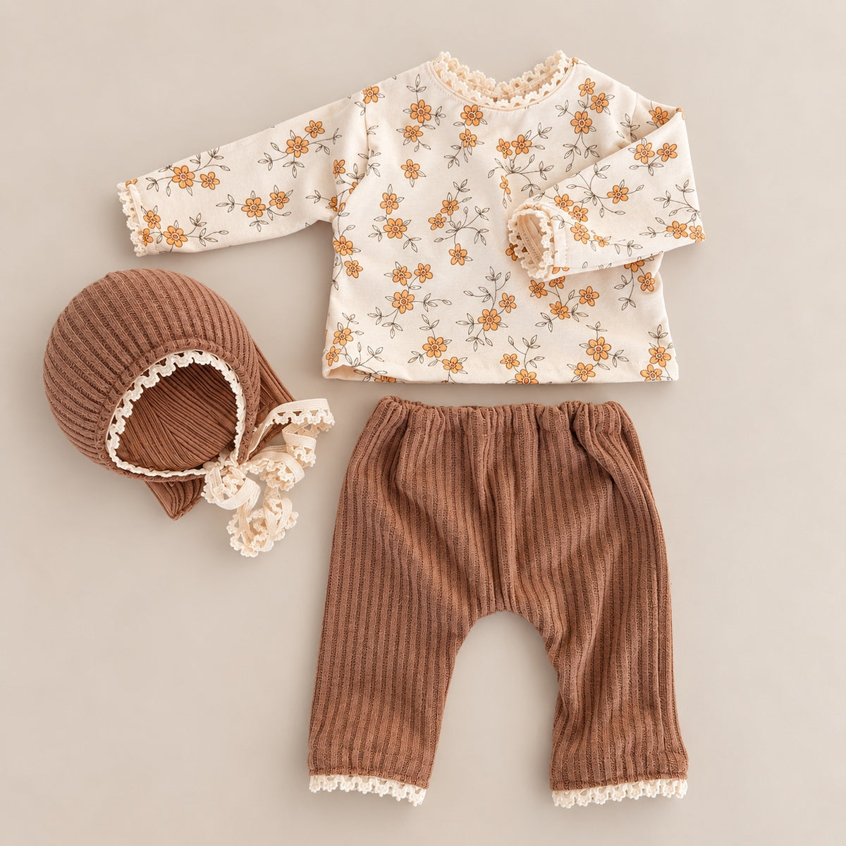 Cream orange floral top with brown ribbed pants and bonnet newborn photography outfit set