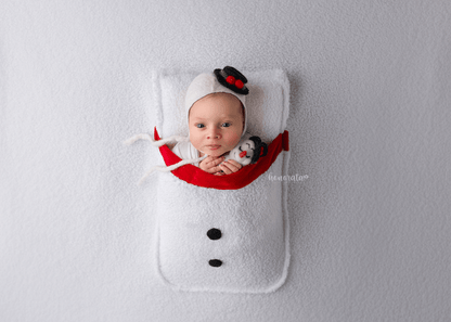 Snowman Backdrop with a pocket and snowman's hat. Newborn photo props featuring a baby in a snowman-themed setup.