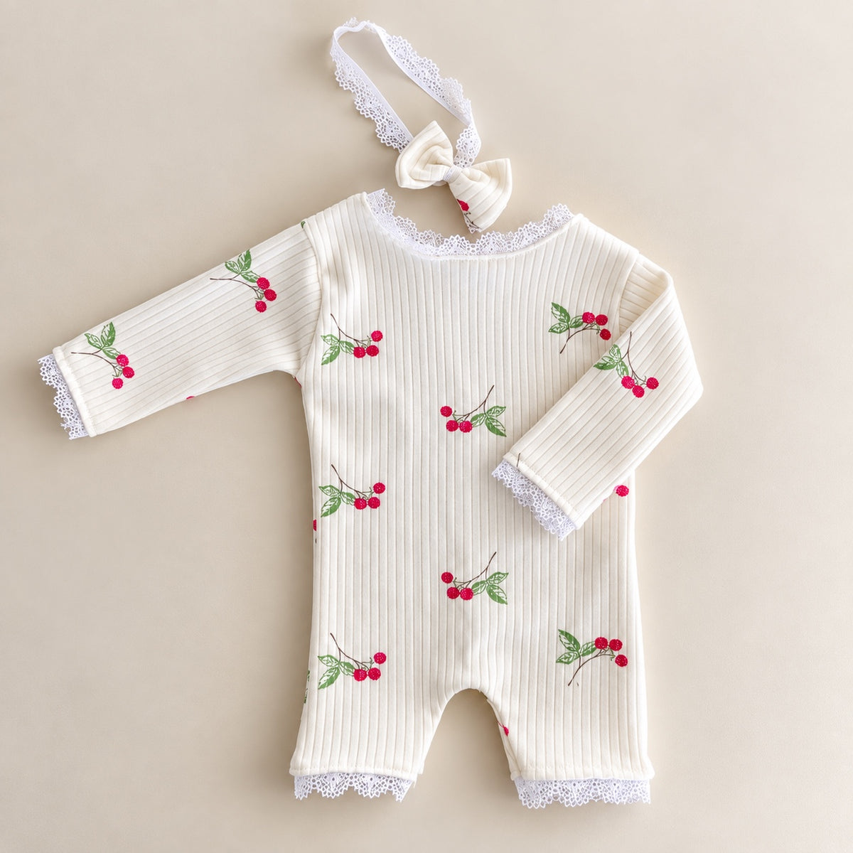 Ivory cherry ribbed newborn romper with lace trim and matching bow headband
