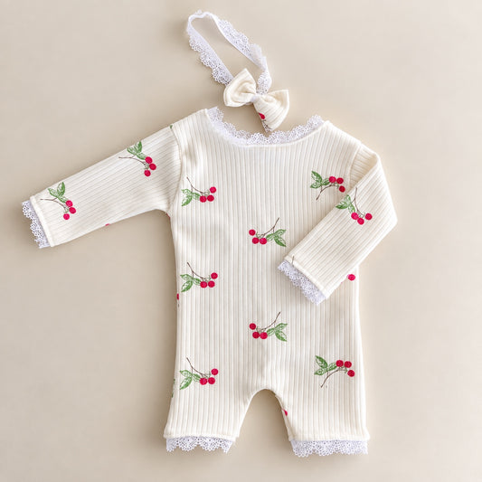 Ivory cherry ribbed newborn romper with lace trim and matching bow headband