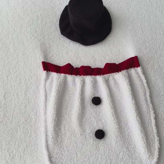 Snowman Backdrop with a pocket and snowman's hat. Newborn photo props displayed on a soft surface.