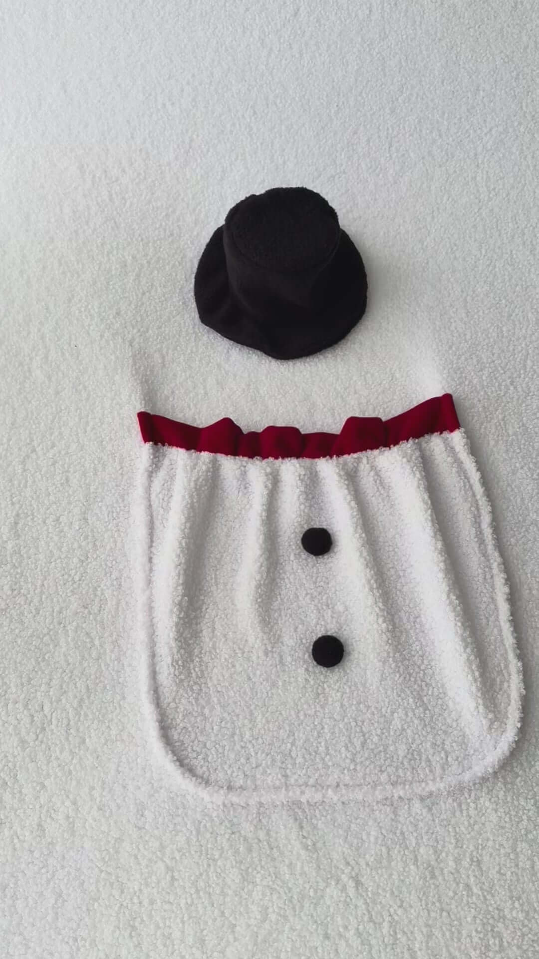 Snowman Backdrop with a pocket and snowman's hat. Newborn photo props displayed on a soft surface.