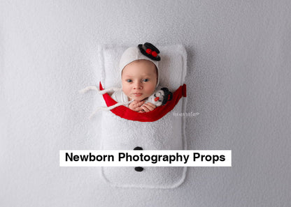 Snowman Backdrop with a pocket and snowman's hat. Newborn photo props featuring a baby in a snowman-themed setup.